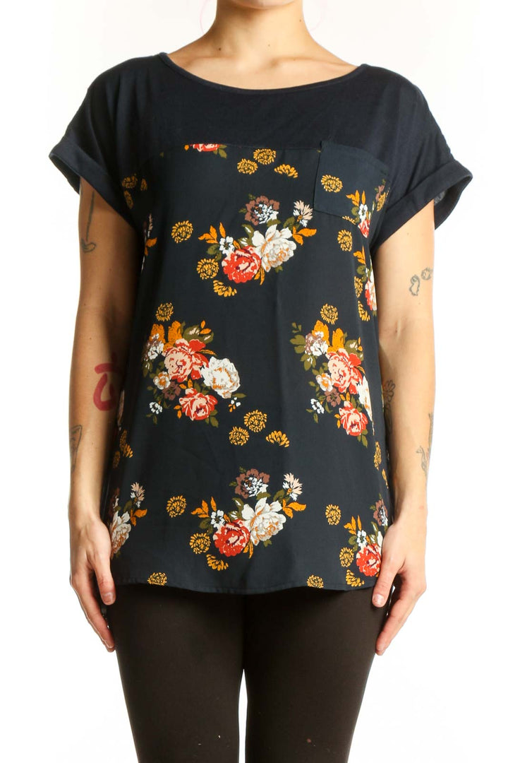 Black floral print short sleeve top by Mason & Belle with red, orange, white, and golden yellow botanical flowers, relaxed fit