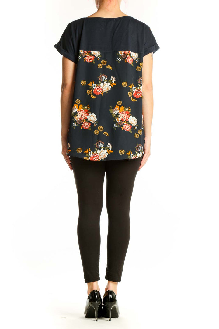 Back view of black floral print Mason & Belle top showing full botanical flower design and relaxed silhouette