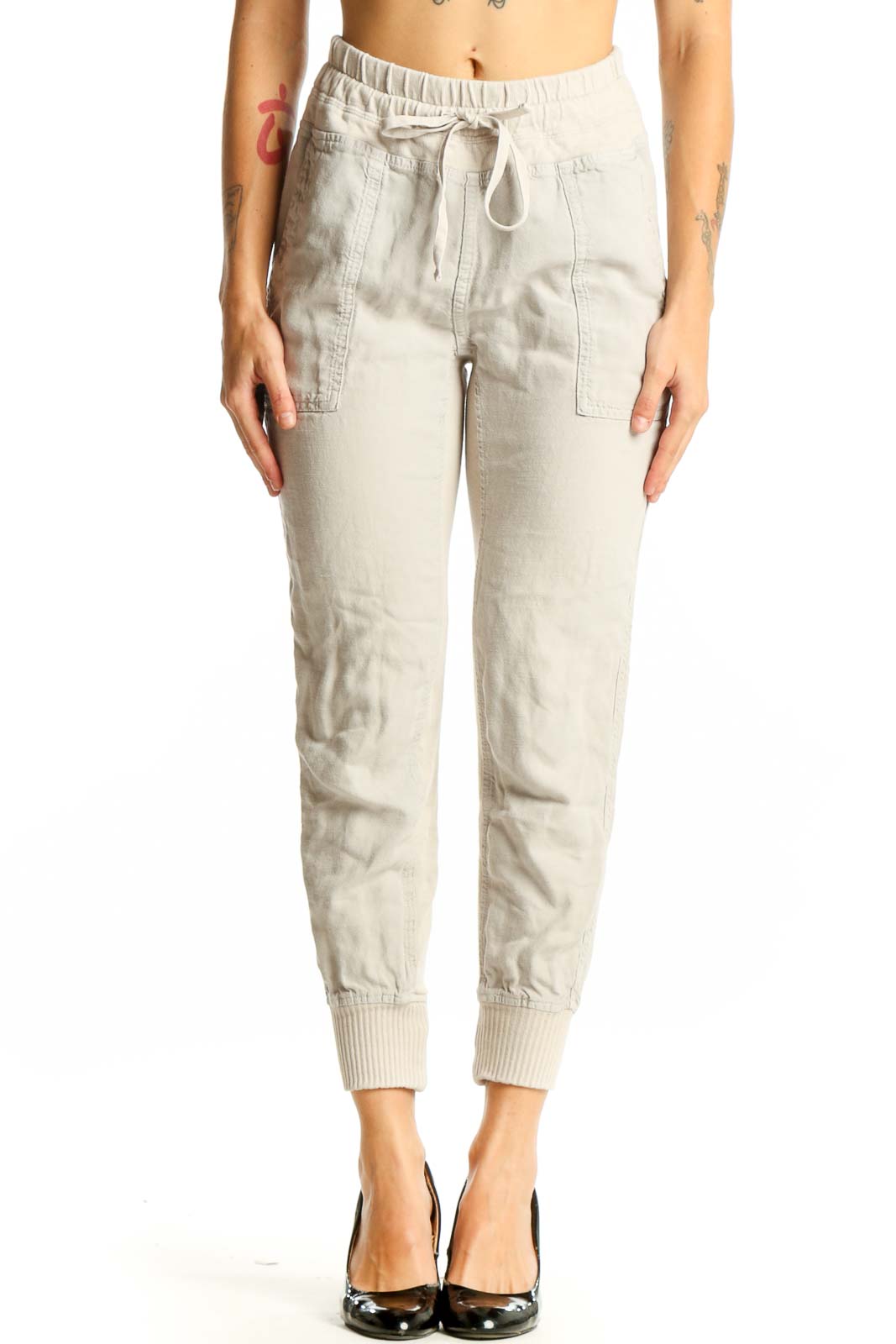 Front view of beige cotton jogger pants with drawstring waist