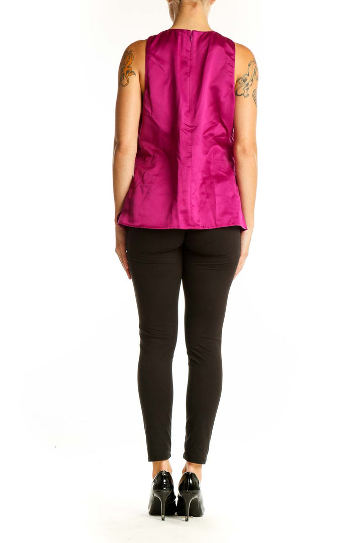 Side view of woman wearing Ann Taylor magenta petal-textured top with black pants