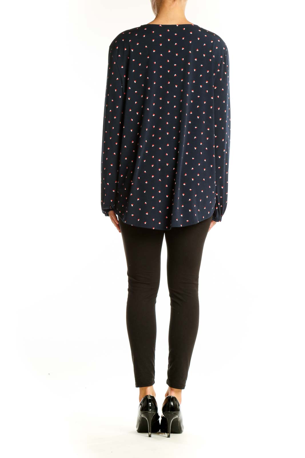 Side view of model wearing Banana Republic navy polka dot wrap blouse with black pants