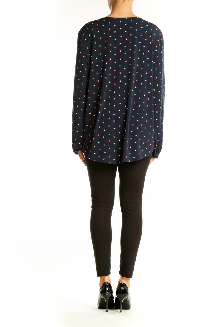 Side view of model wearing Banana Republic navy polka dot wrap blouse with black pants