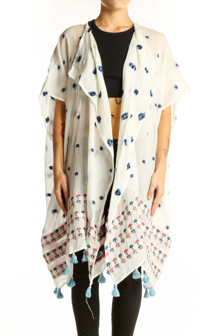 Front view of white J.Crew kimono jacket with blue floral print and tassels