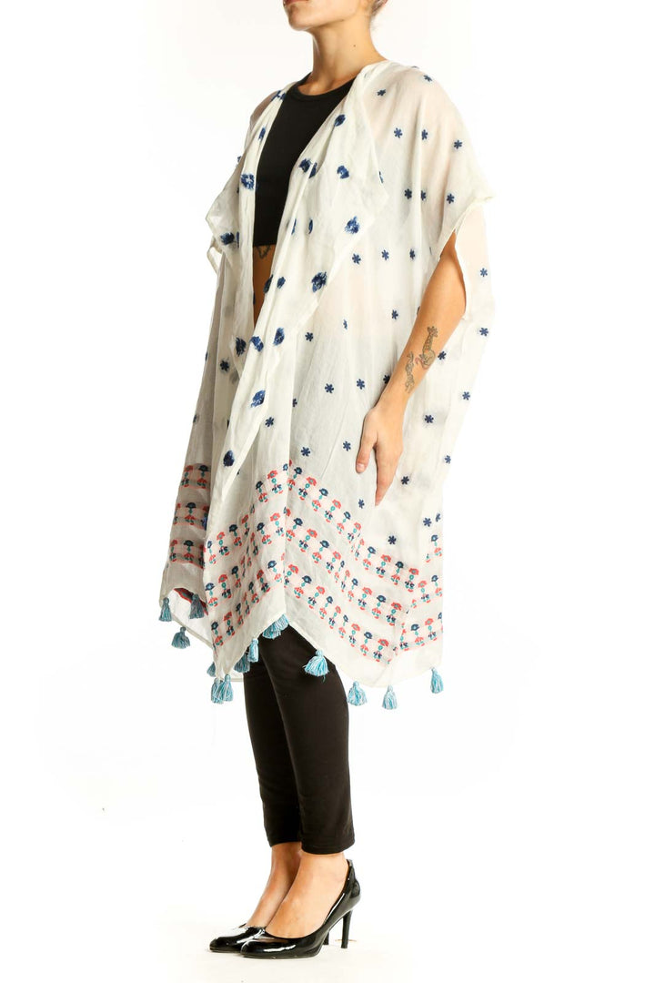 Front view of white J.Crew kimono jacket with blue floral print and tassels