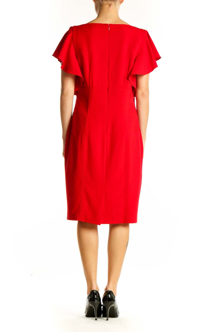 Side view of red Calvin Klein cocktail dress showing fit and pockets