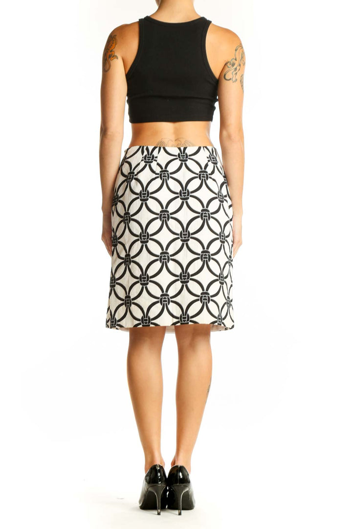 Side view of Talbots white and black geometric print A-line skirt with black top
