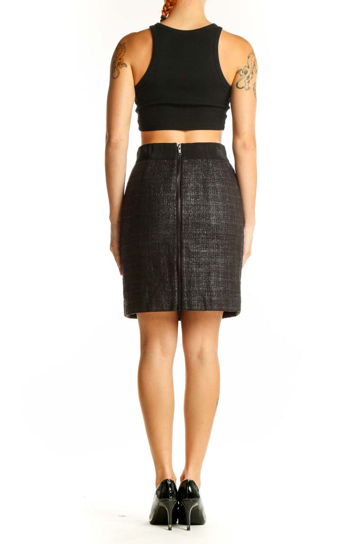 Side view of model wearing Milly black textured pencil skirt with black crop top