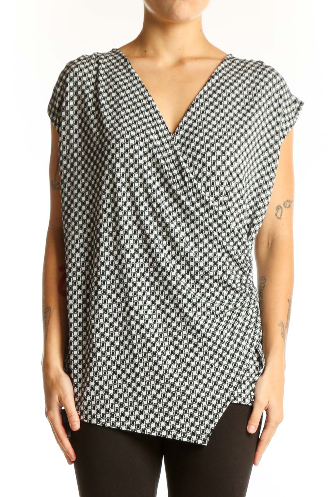 Front view of Ann Taylor black and white houndstooth wrap top with V-neck