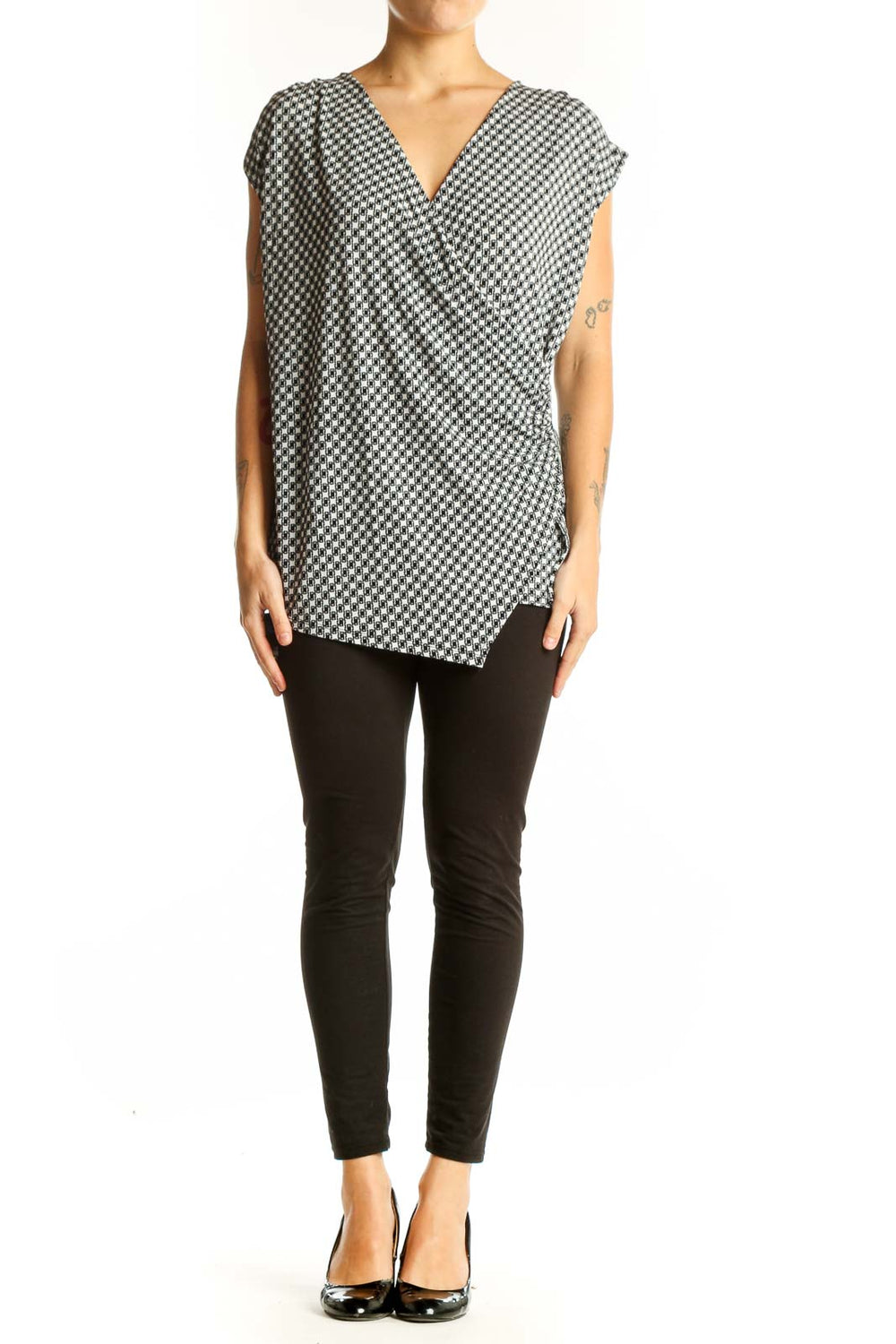 Front view of Ann Taylor black and white houndstooth wrap top with V-neck