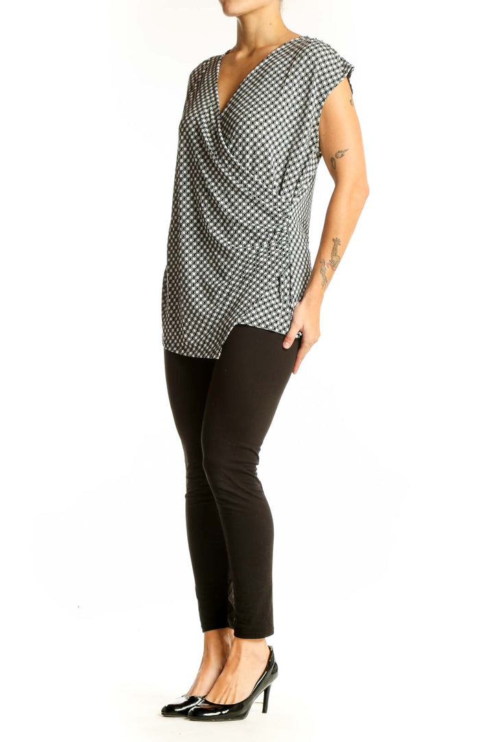 Front view of Ann Taylor black and white houndstooth wrap top with V-neck