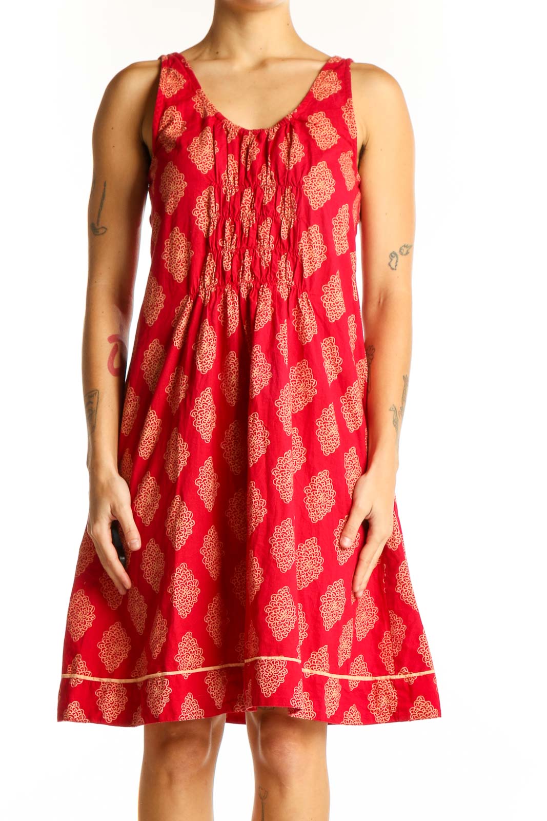 Front view of red cotton sundress with golden floral print by Mata Traders