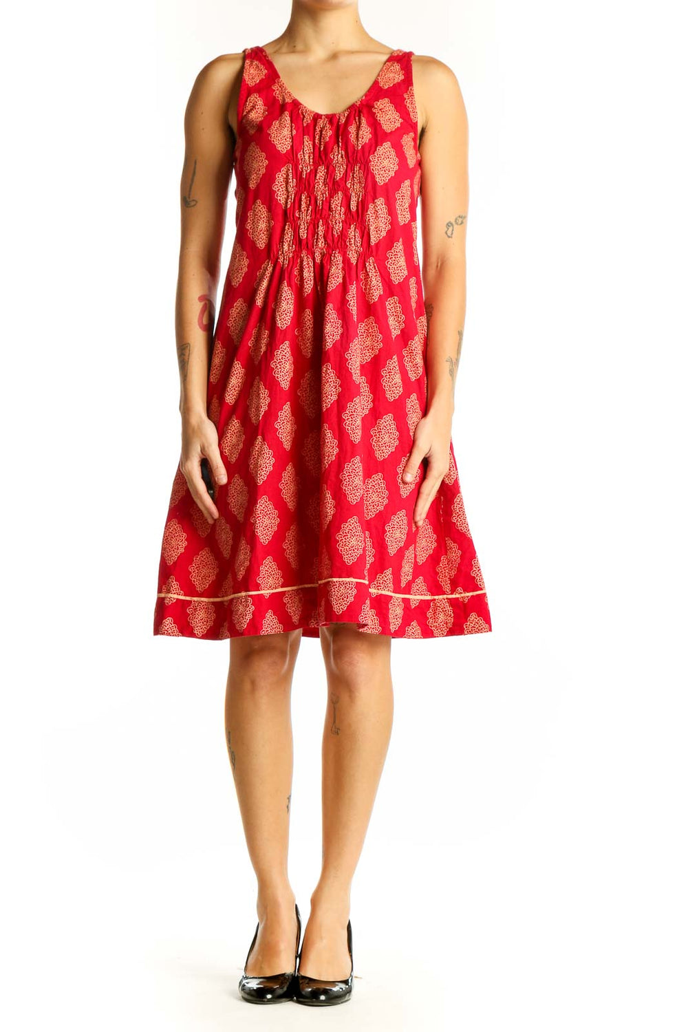 Front view of red cotton sundress with golden floral print by Mata Traders