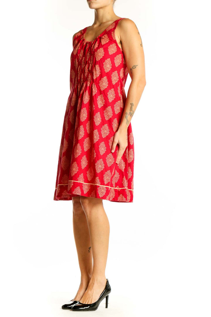 Front view of red cotton sundress with golden floral print by Mata Traders