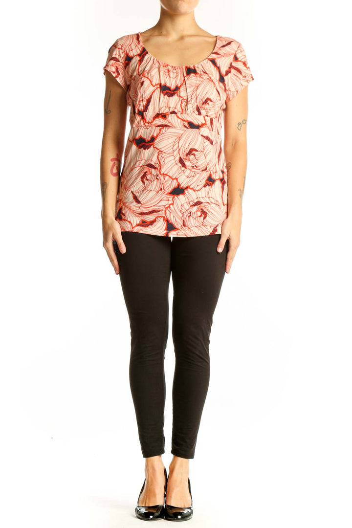 Front view of Ann Taylor coral floral print top with ruffle neckline