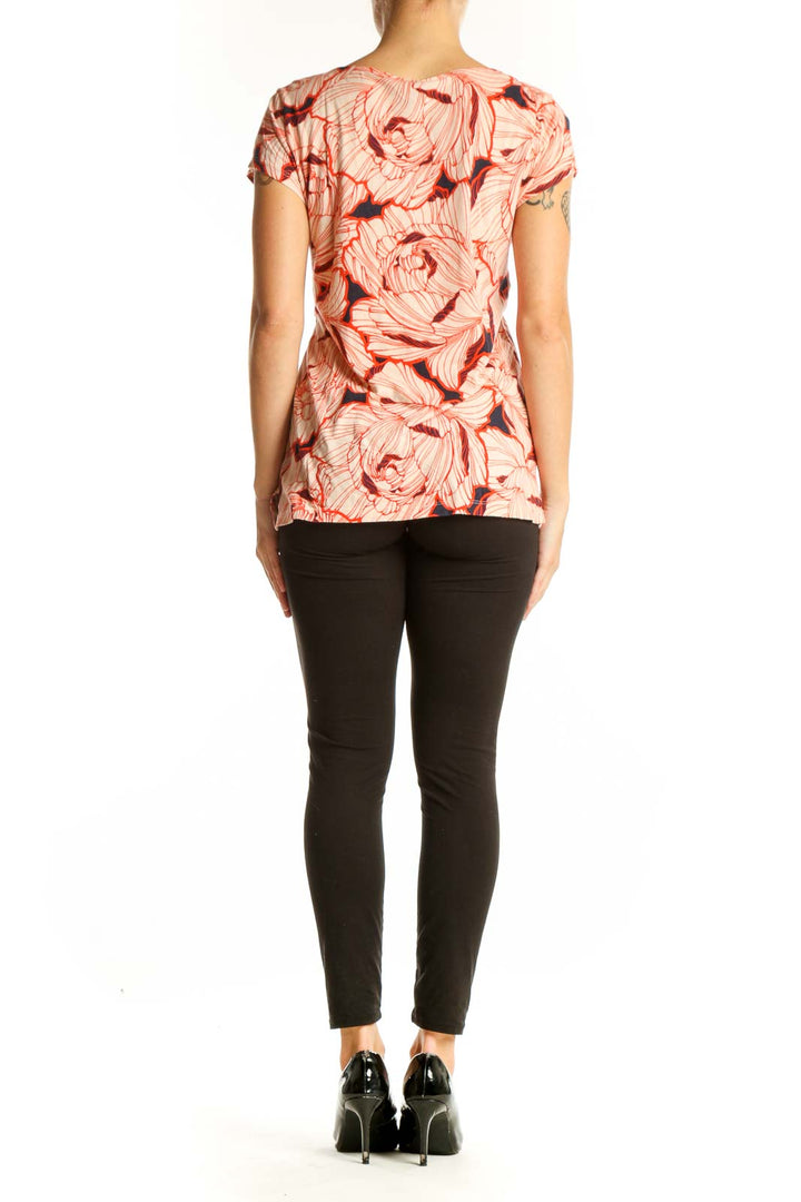 Side view of Ann Taylor coral floral print top on model