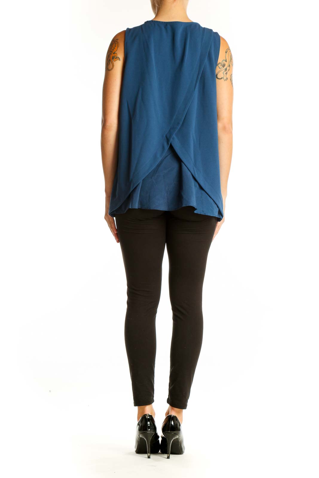 Side view of blue sleeveless Banana Republic tank top on model with black pants