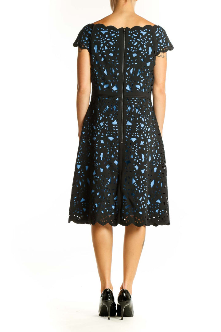 Back view of Nue by Shani Black and Blue Floral Lace Cocktail Dress showing full length