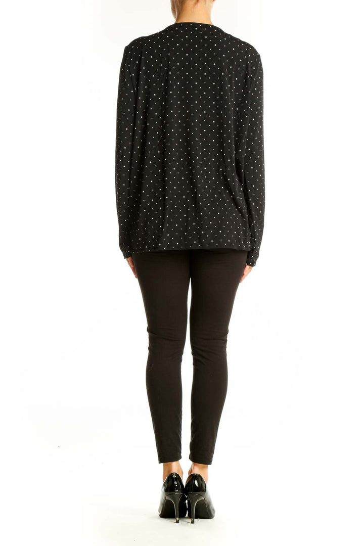 Side view of Banana Republic black polka dot V-neck wrap top on model