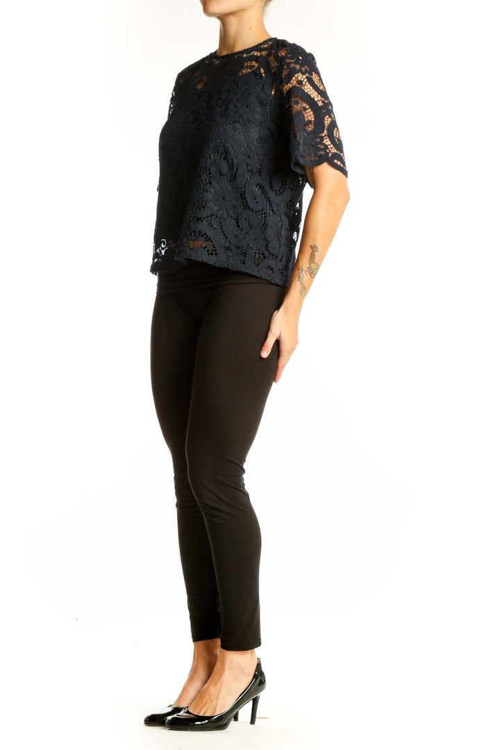 Front view of Nanette Lepore black lace top with floral overlay and short sleeves