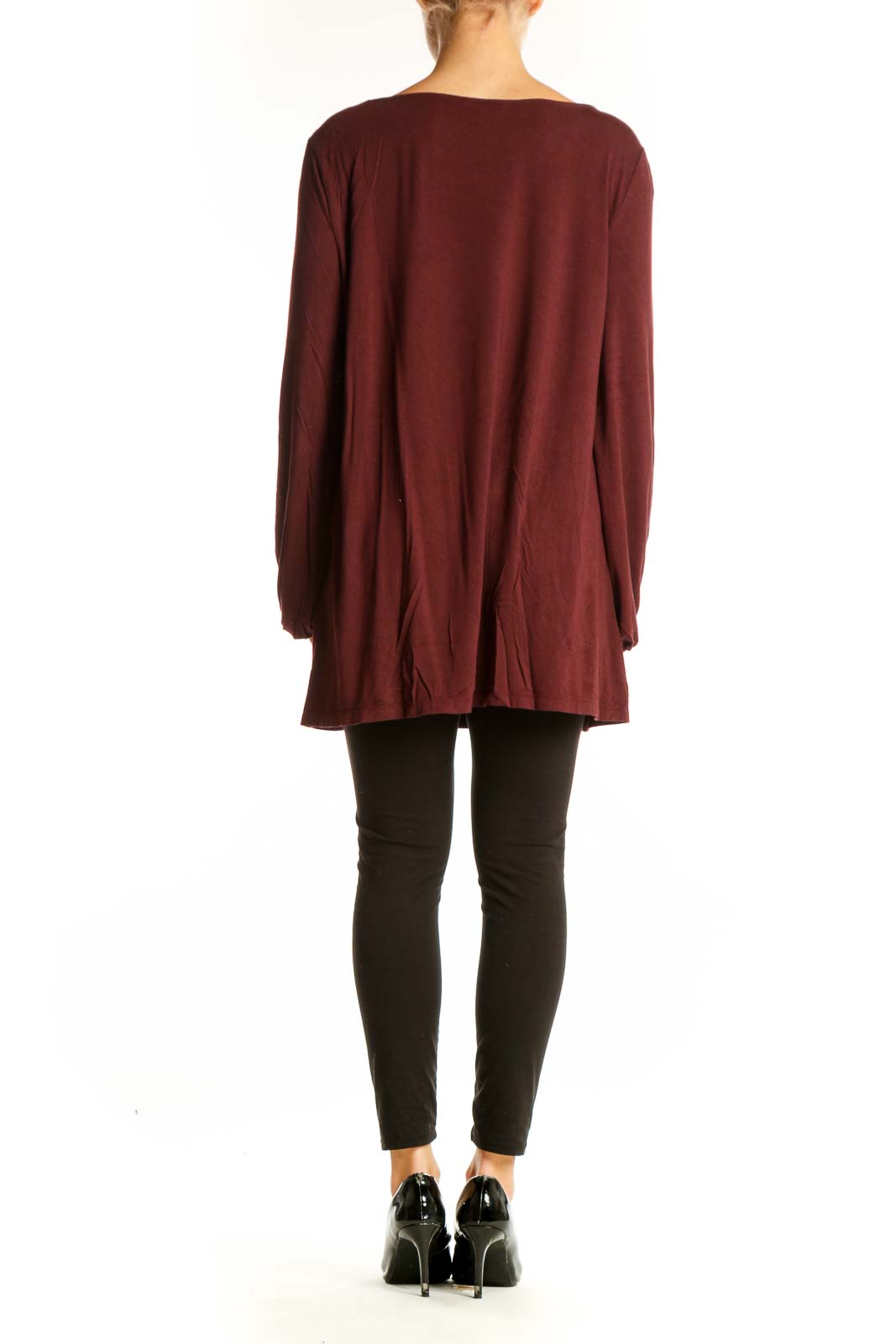 Side view of Ann Taylor burgundy long sleeve tunic top on model with black pants