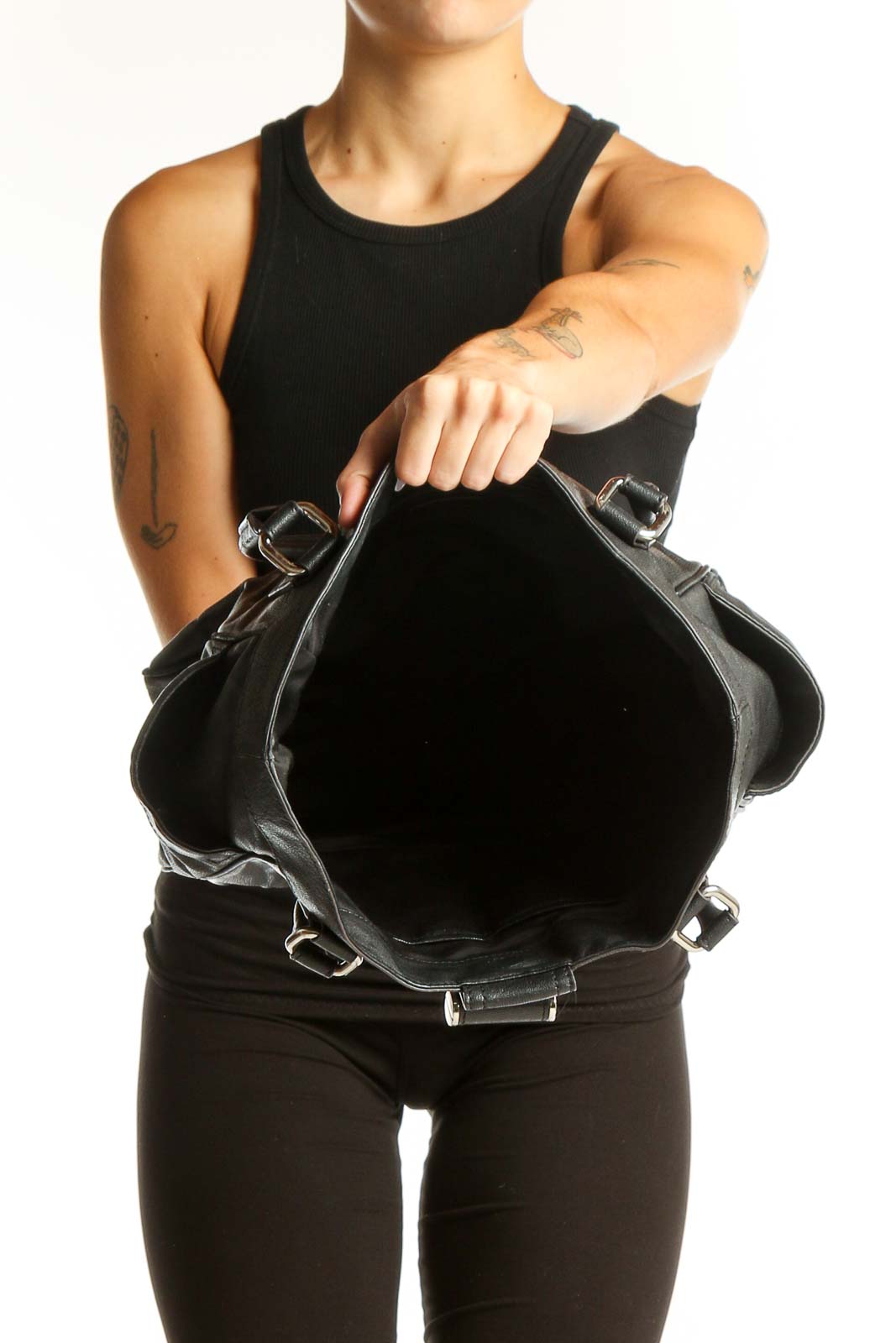 Side view of Milly black leather tote bag worn on shoulder