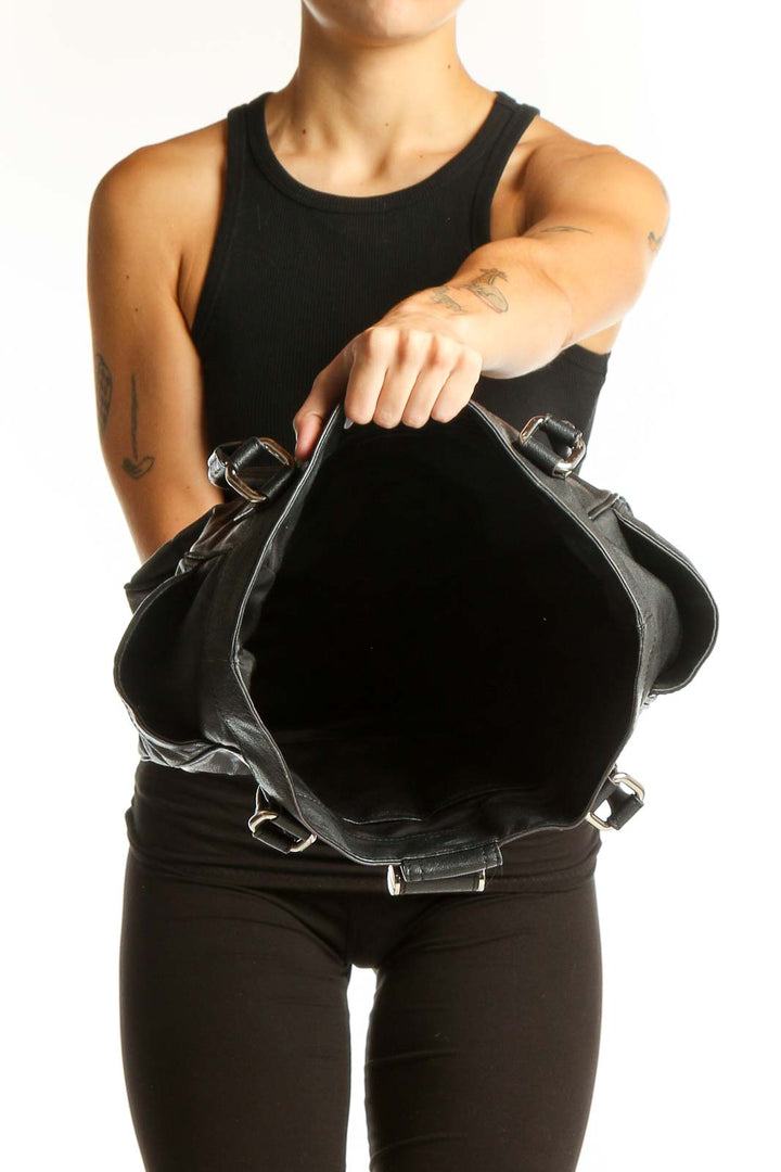 Side view of Milly black leather tote bag worn on shoulder