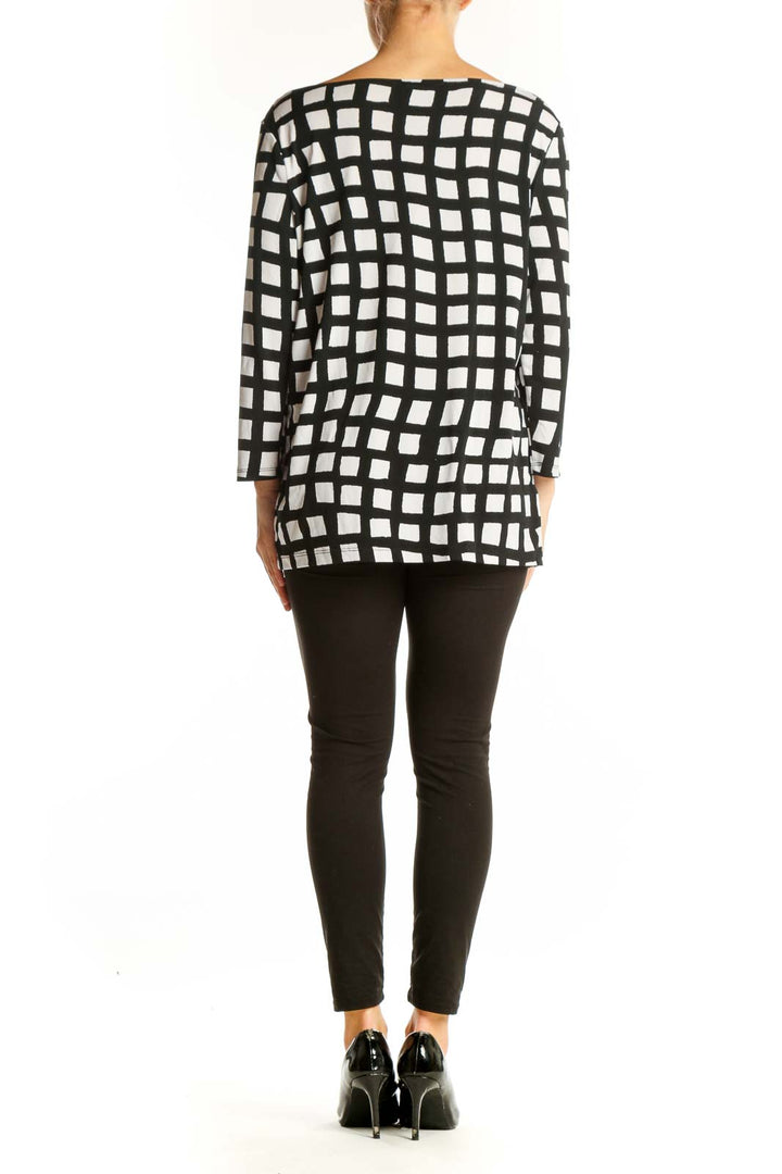 Back view of Ann Taylor black and white geometric print top on model