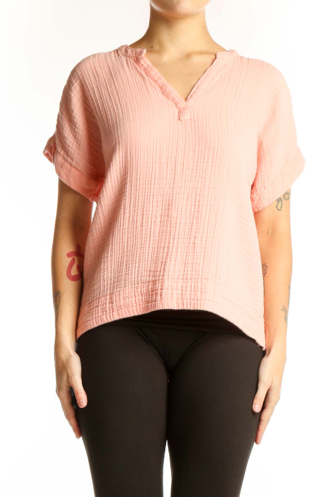 Pink ribbed cotton V-neck short sleeve top with cropped hem, front view on model