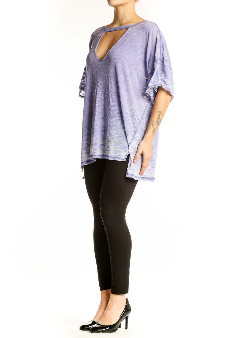Free People purple cutout V-neck top with ruffled sleeves and asymmetrical hemline, front view on model