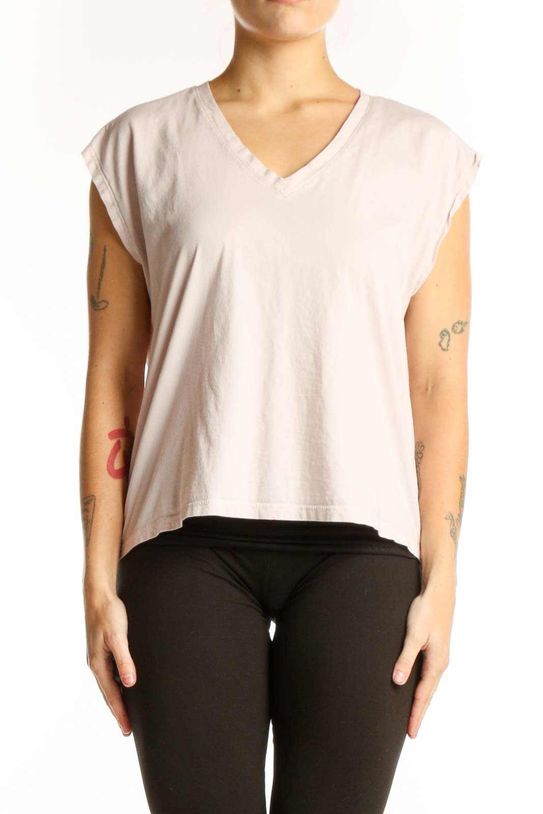 Cream cotton v-neck cap sleeve top with cropped silhouette, front view on model