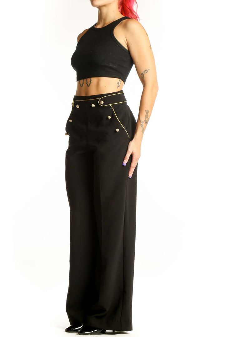 Black wide-leg pants with gold stud details and high-waisted silhouette, front view