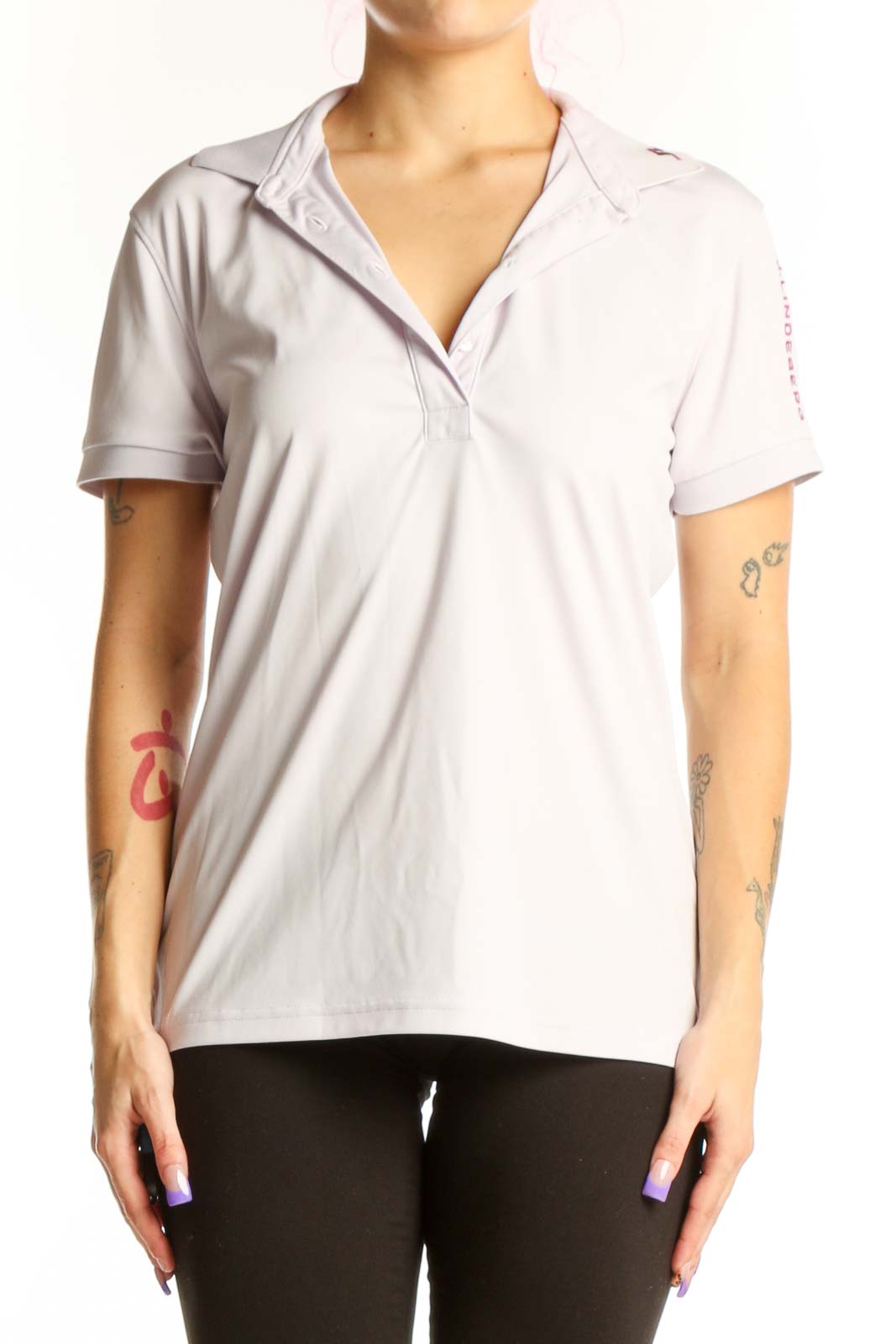 White polo short sleeve top with collar and button-front closure, displayed on model