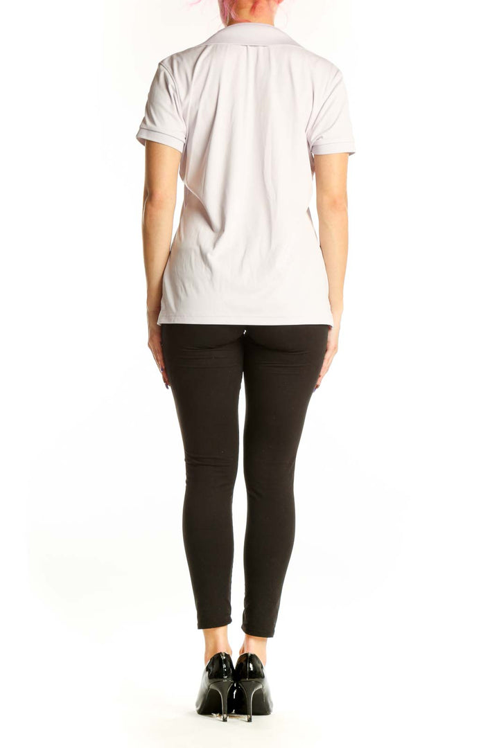 Back view of white polo short sleeve top showing J. Lindbergh branding on sleeve