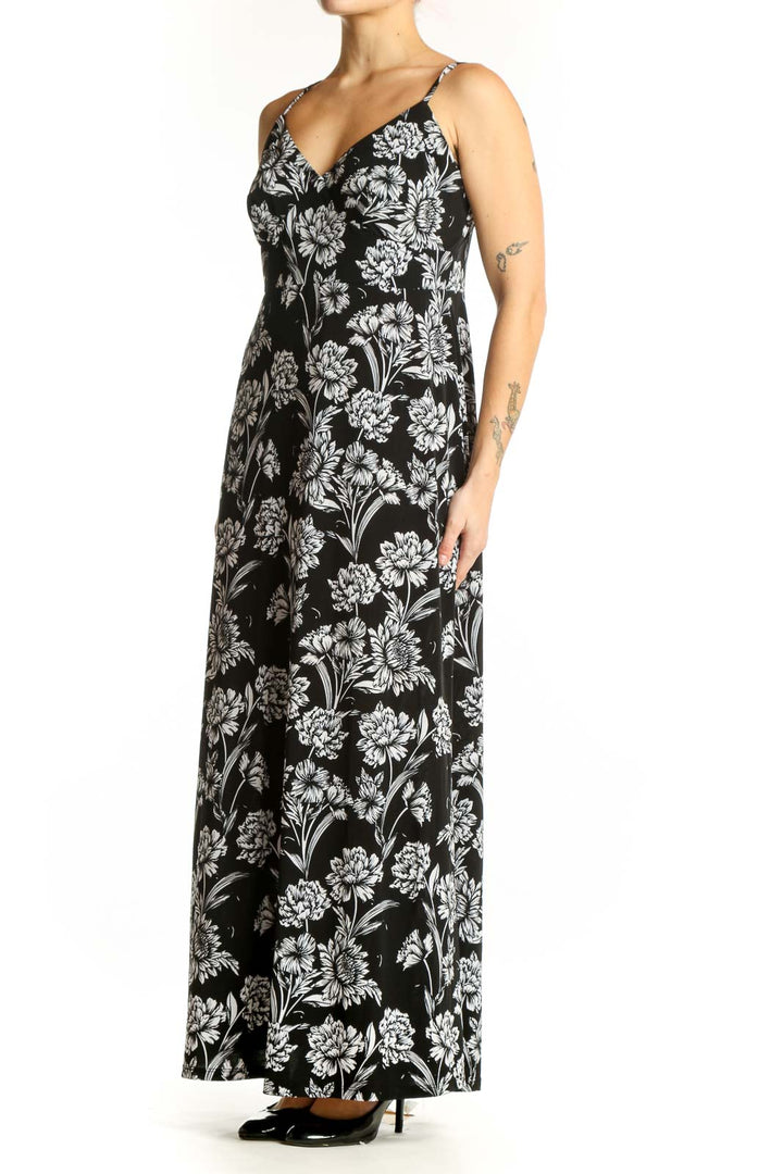 Black and white floral maxi camisole dress with V-neckline and adjustable straps, front view