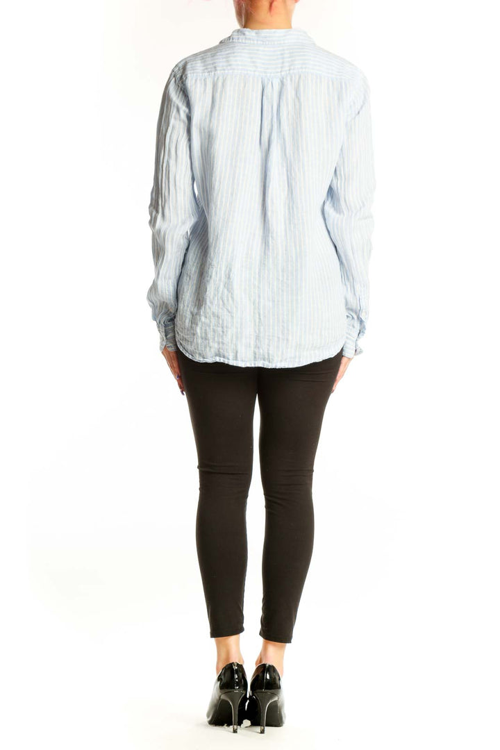 Blue and white striped linen button-up shirt back view on model, size S