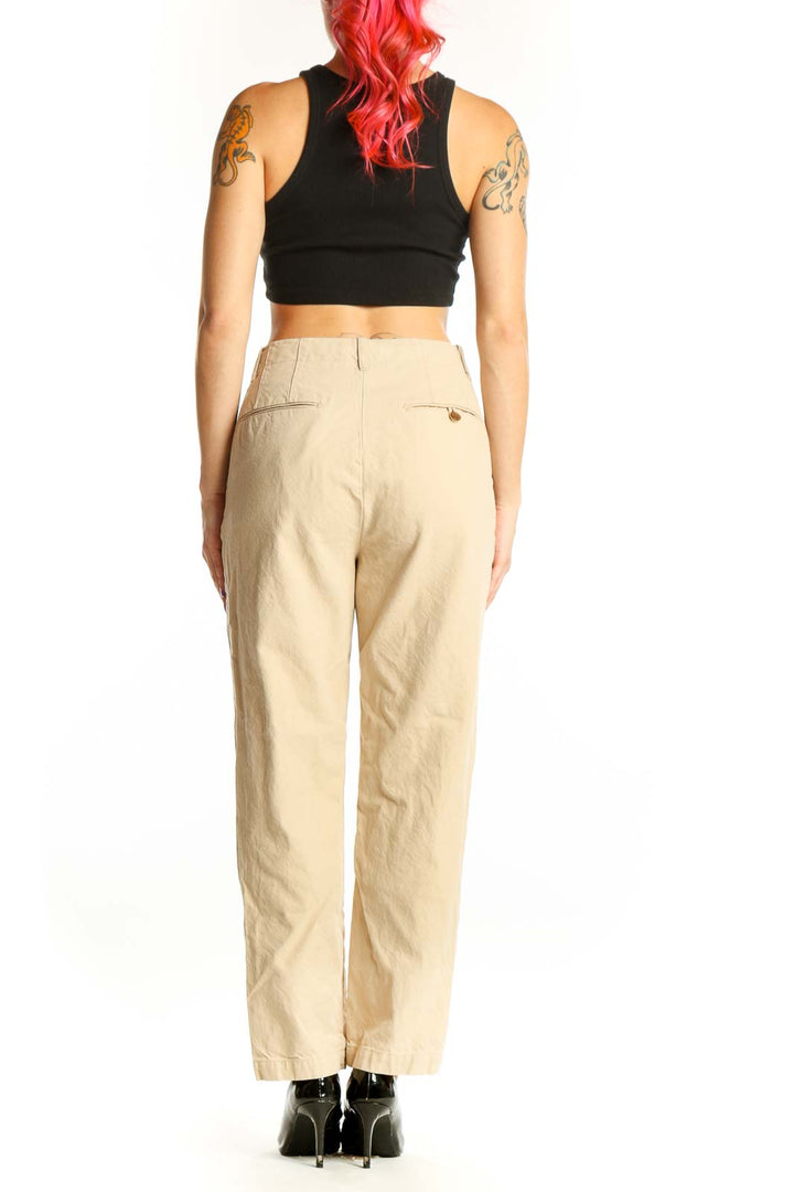 Back view of cream chino pants showing classic silhouette and functional side pockets