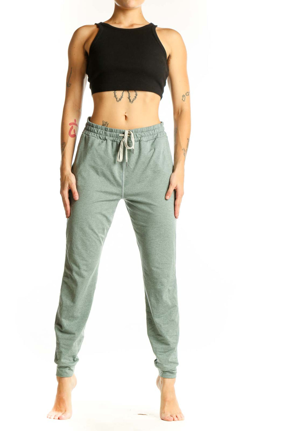 Front view of sage green Vuori jogger pants with drawstring waist