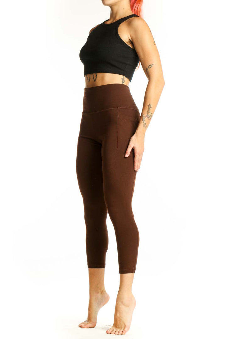 Front view of brown high-waisted capri leggings from Athleta