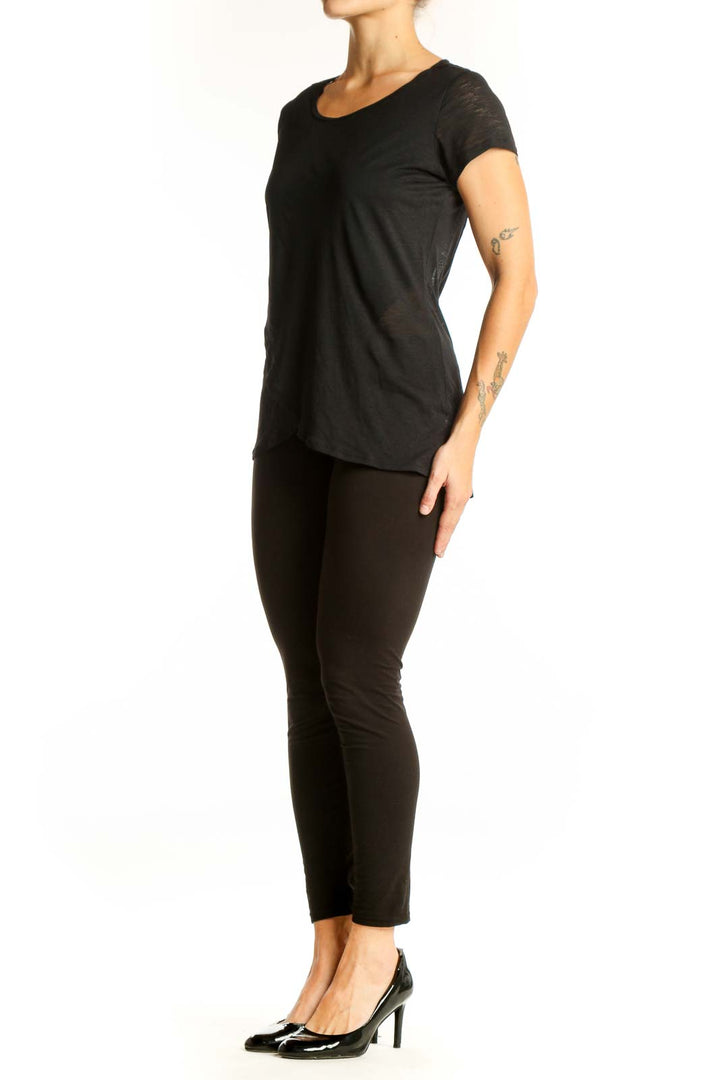 Front view of SilkRoll black asymmetrical hem t-shirt on model