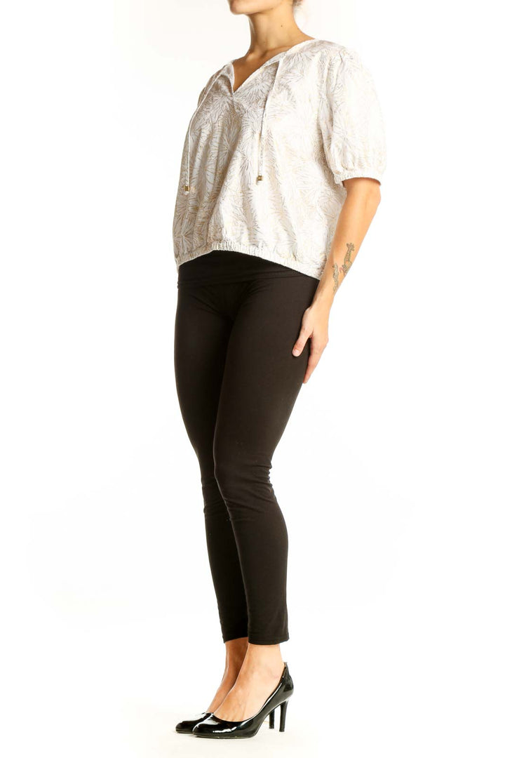 Front view of Michael Kors white cotton blouse with floral embroidery and puff sleeves