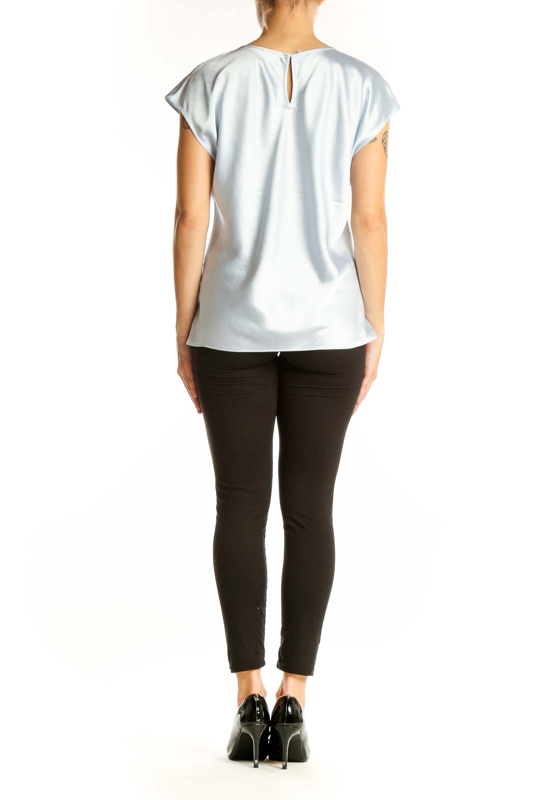 Side view of woman wearing light blue Express top with black pants