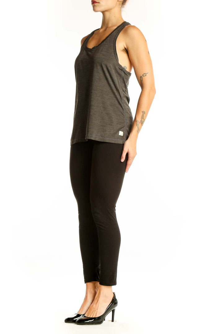 Front view of Vuori olive green racerback tank top on model