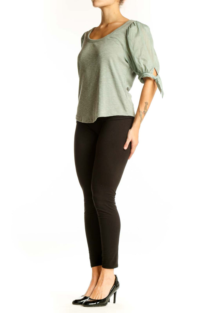 Front view of sage green Gap top with puff sleeves and ribbed texture