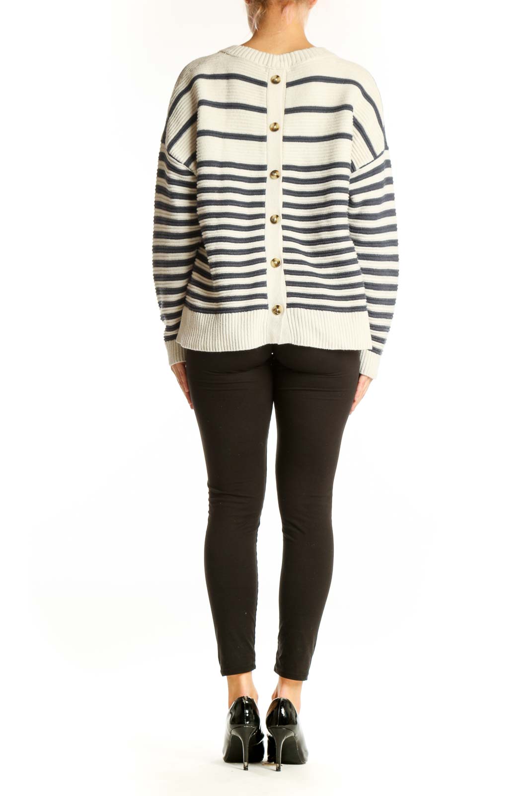 Side view of model wearing Madewell cream and navy striped knit sweater with black pants
