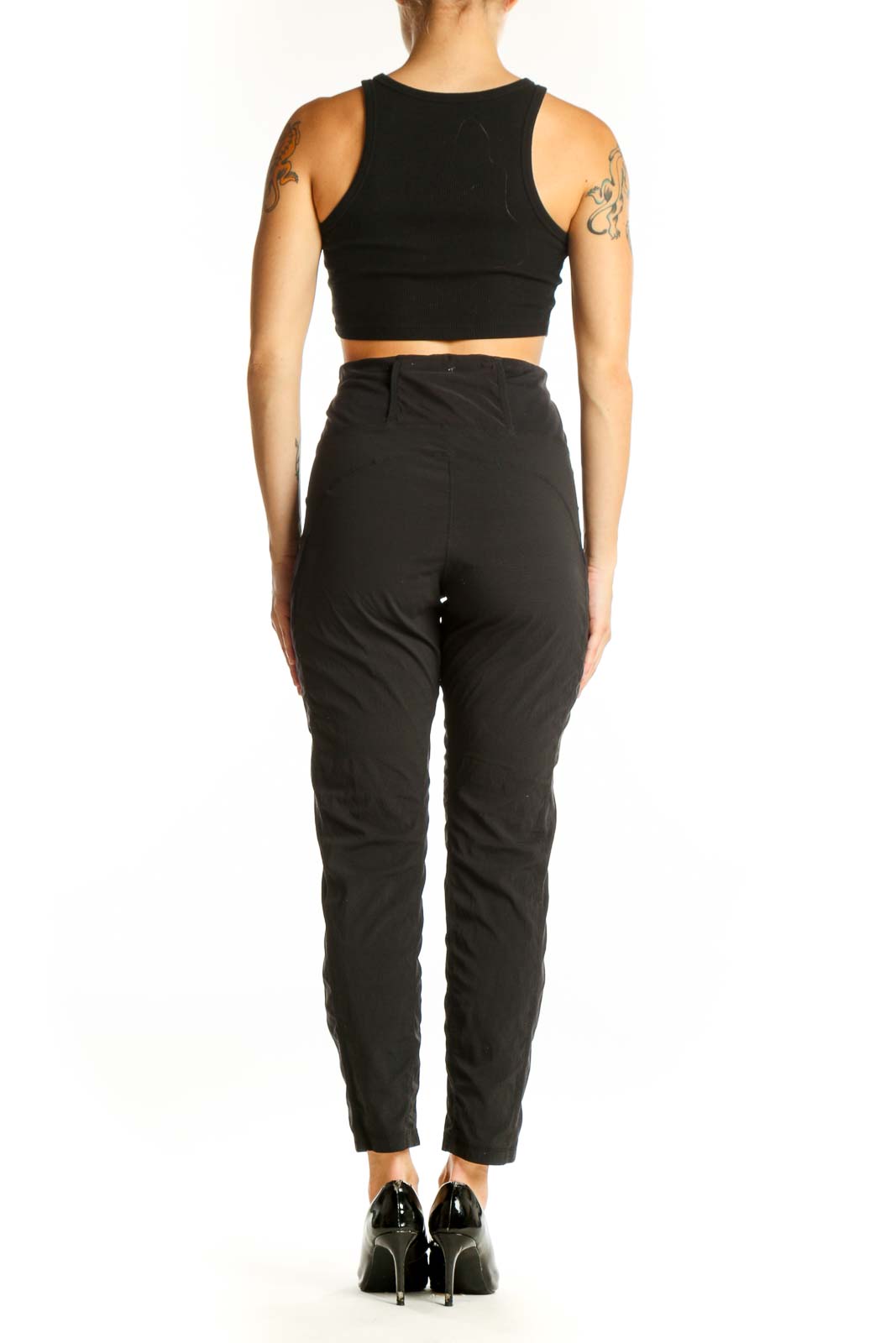 Side view of woman wearing black Athleta leggings and crop top