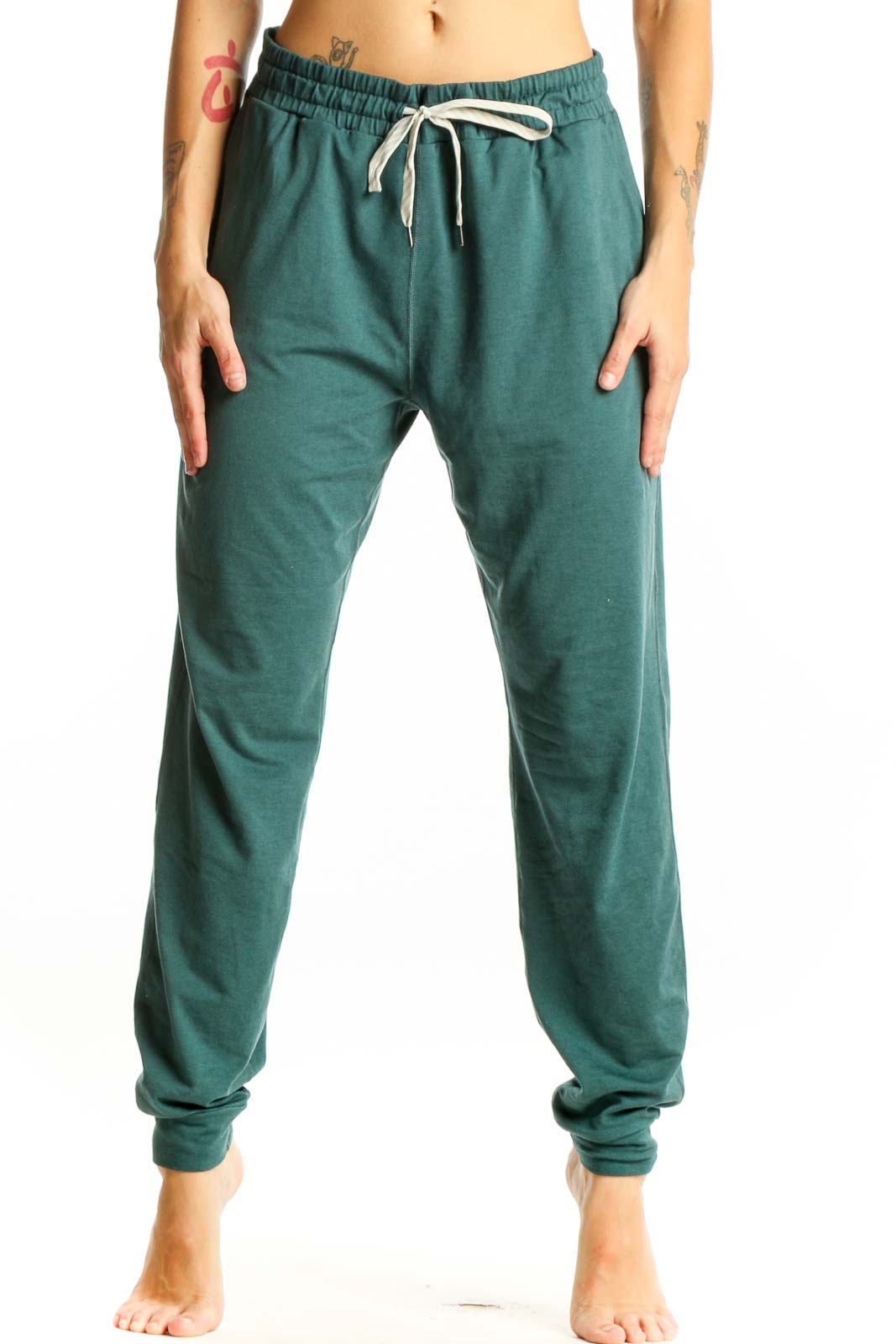 Front view of green Vuori jogger pants with drawstring waist