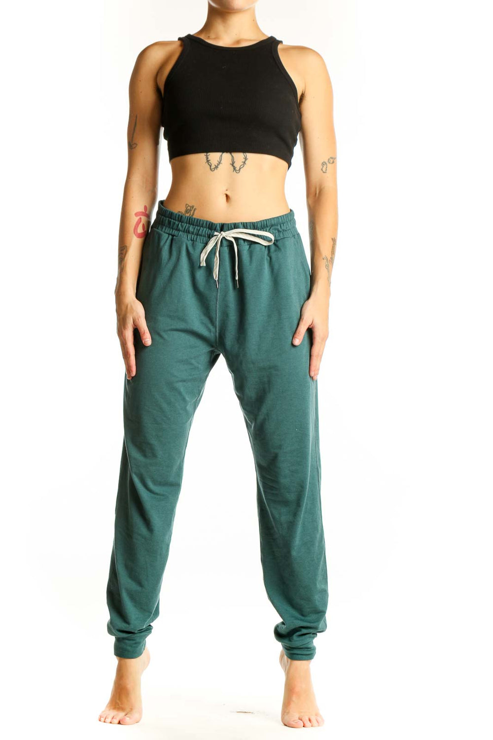 Front view of green Vuori jogger pants with drawstring waist