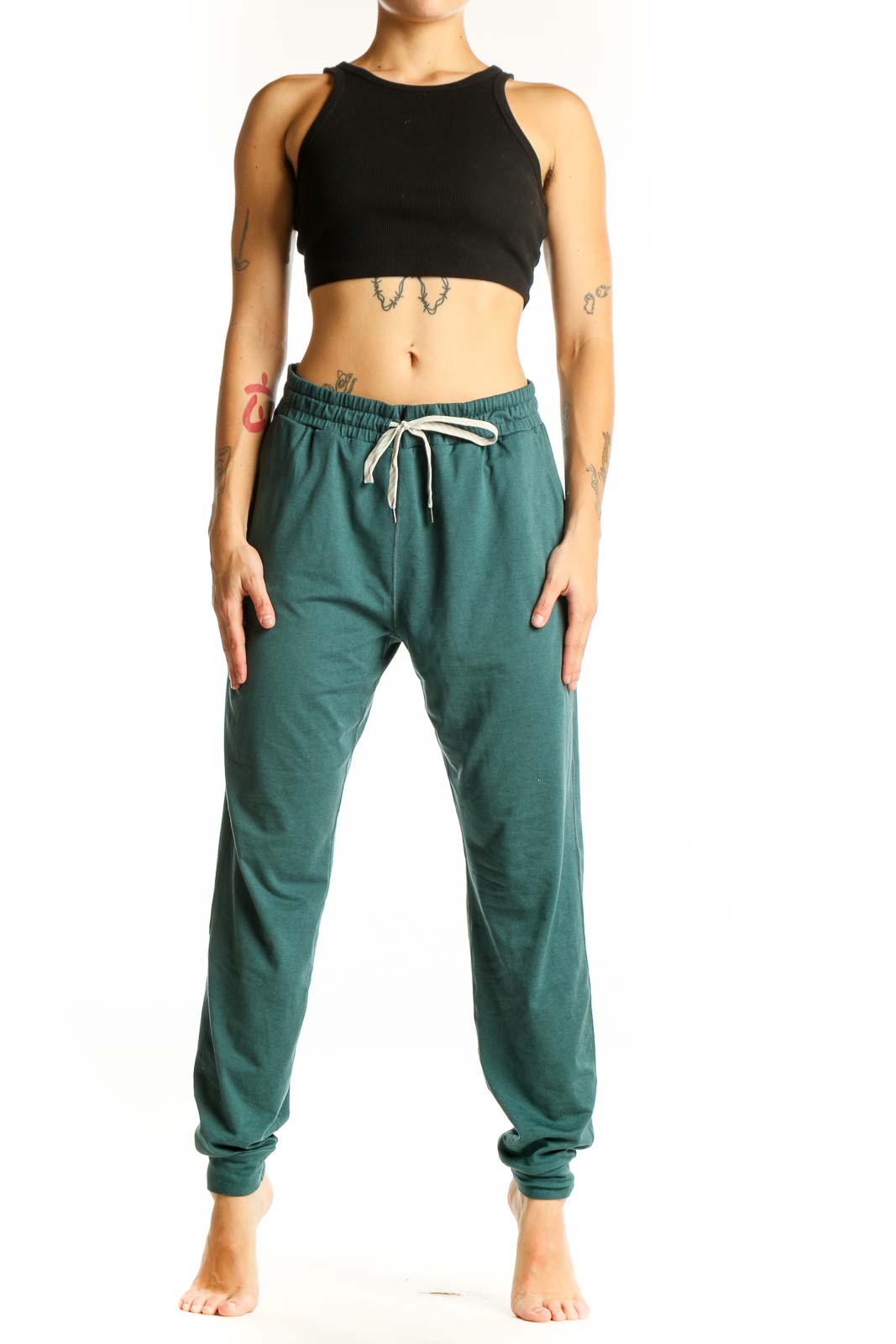 Front view of green Vuori jogger pants with drawstring waist