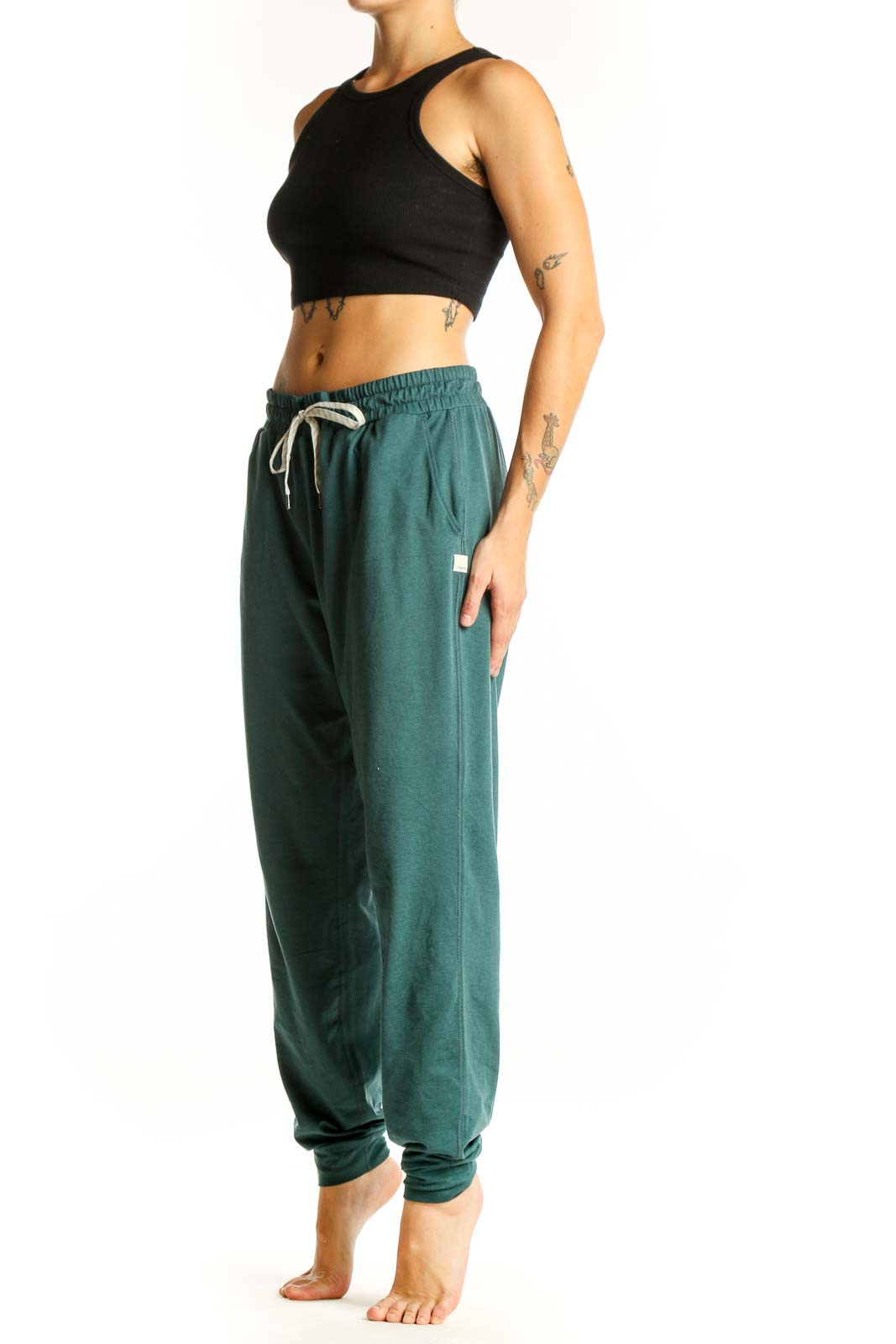 Front view of green Vuori jogger pants with drawstring waist