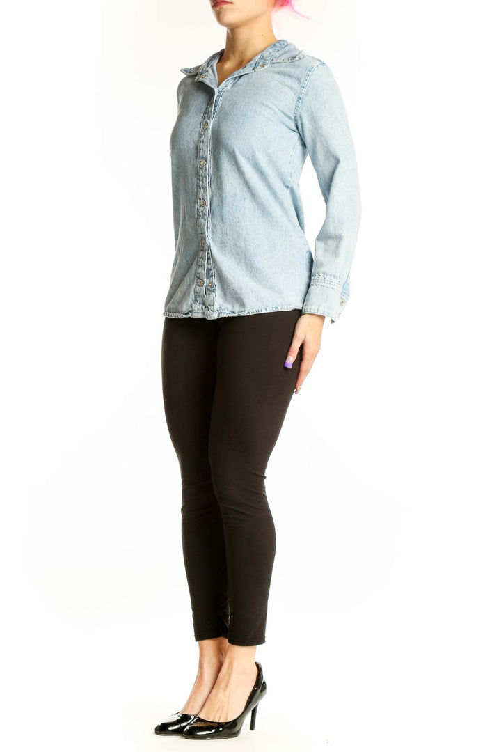 Light blue Mango denim button-up shirt front view, XS size with collar and long sleeves